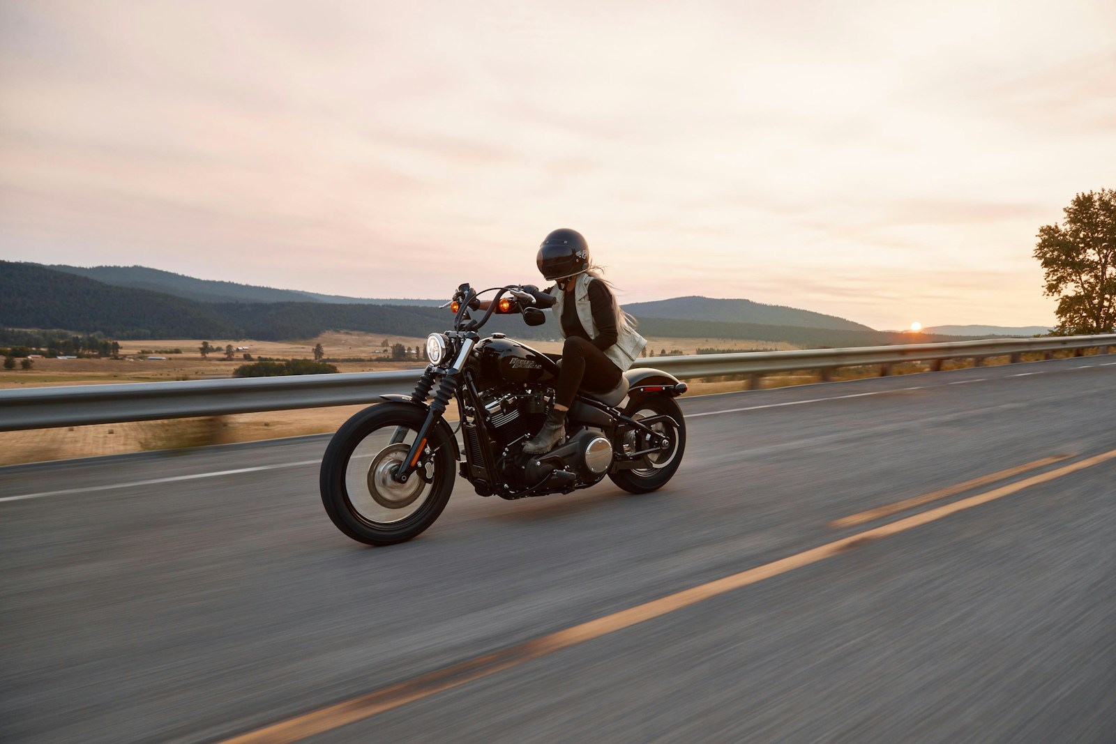 Custom hand-built steel motorcycle in industrial brick workshop